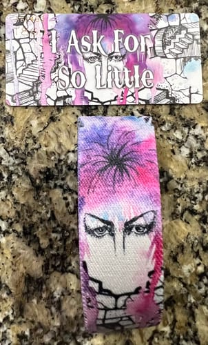 Customer's I Ask For So Little Labyrinth Bracelet with a colorful watercolor design on a stone surface.