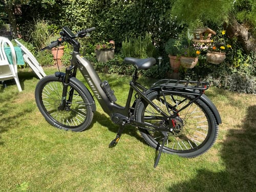 Customer's Lankeleisi MG600 Lite electric bike parked on green grass in a sunny garden.