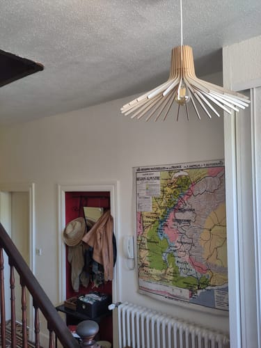 Customer's Ampoule LED E27 12W installed in a stylish wooden geometric pendant light hanging in a room.