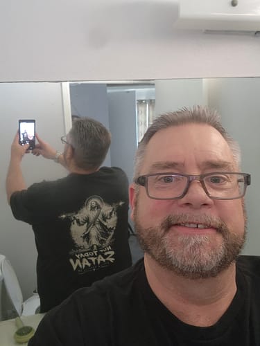 Customer's Not Today Satan Uzi T-Shirt worn in a mirror reflection, showing the black fabric and back graphic design.