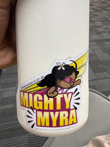 Customer's custom cut-to-shape sticker of a superhero character named Mighty Myra applied to a white water bottle.