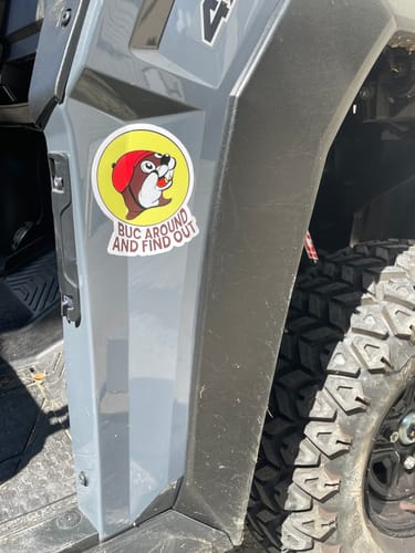 Customer's circular Cut to Shape Sticker featuring a cartoon beaver graphic attached to a vehicle panel.