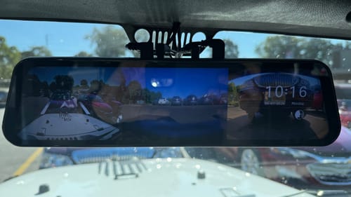 Customer's WOLFBOX G900TriPro installed on a Jeep Wrangler's rearview mirror, displaying a multi-view camera feed.