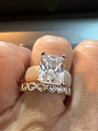 Customer's hand wearing the emerald cut silicone ring paired with a sparkling beaded band.