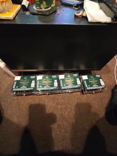 Customer's four dark green Pre Rolls 100ct boxes arranged in a row on a floor surface.