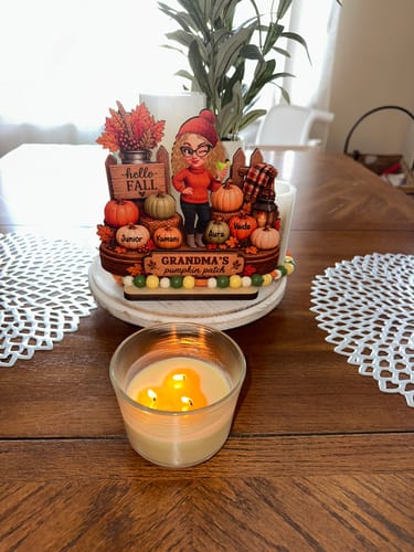 Customer's Hello Fall Grandma's Pumpkin Patch plaque sitting on a table with a glowing candle in front
