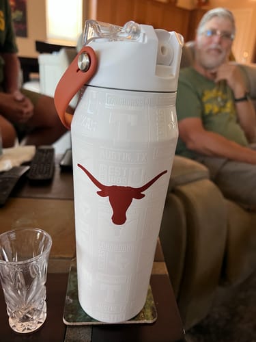 Customer's white Texas Longhorns Bottle Buddy standing on a coaster.