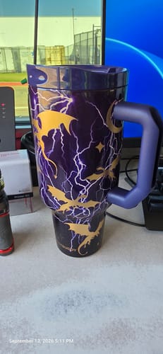 Reviewer's Thicc Buddy mug in Electric Ember, featuring a purple and gold lightning and dragon pattern on a desk.