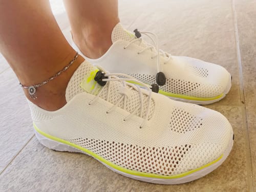 Reviewer's white Xdrain Pro Knit water shoes in a side view, showing the lightweight knit upper and slim profile.