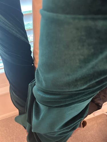 Customer's Super Soft Spandex Velvet fabric in deep green draped over a surface