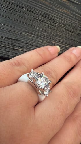 Customer's Rinfit silicone ring with three round cubic zirconia stones worn on a finger