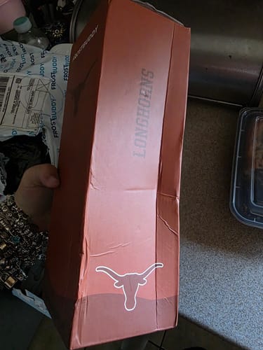 Customer's Bottle Buddy packaging with damaged, bent corners after delivery.