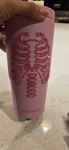 Customer's pink To-Go Buddy cup held in hand, featuring a sparkling, iridescent rib cage design.