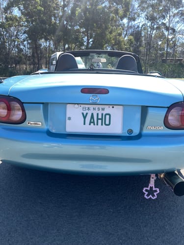 Customer's JDM Plate Bracket holding a white number plate on the rear of a light blue convertible car.