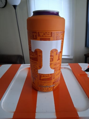 Customer's orange Tennessee Vols Universal Buddy cooler with a large white T logo, sitting on an orange surface.