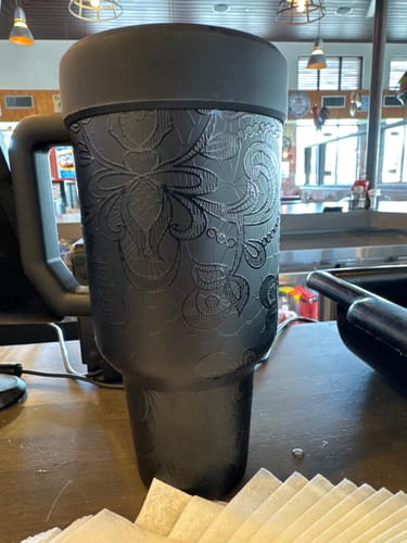 Customer's Thicc Buddy 50oz mug in black lace pattern, standing on a counter.