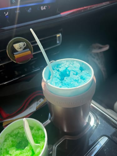 Customer's To-Go Buddy cup holder used for holding a blue shaved ice treat in a car