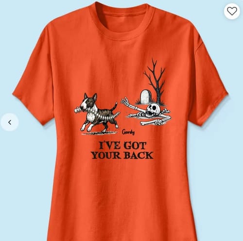 Customer's orange t-shirt showing a cartoon dog running with a backbone and a skeleton near a tombstone.