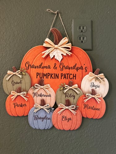 Customer's Grandma and Grandpa's Pumpkin Patch wooden door hanger featuring names of grandchildren on pumpkin cutouts.