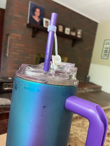 Reviewer's blue and purple Thicc Buddy 40oz cup with a purple straw and custom plastic attachment on the lid.