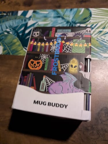 Customer's Mug Buddy packaging featuring magical library and Halloween-themed illustrations.