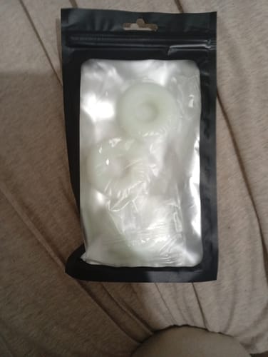 Customer's pack of three white C-Ring items inside a sealed, clear plastic and black pouch.