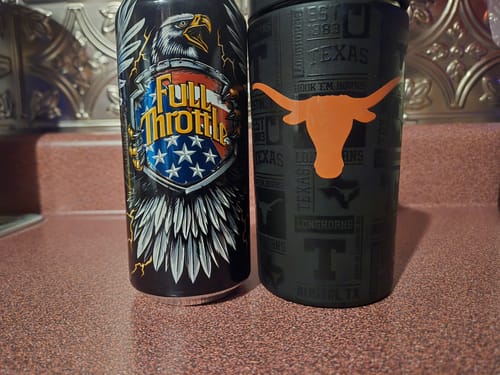 Customer's black Texas Longhorns Universal Buddy next to a drink can on a countertop