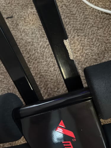 Customer's Dual-Track Ab Machine shows paint chipping on the black metal track after three weeks of use.