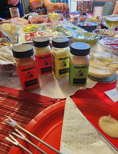 Customer's four Chooki's Original Chicken Salt bottles displayed on a table set for a dinner party.