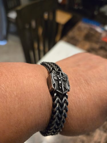 Customer's St. Michael Defend Us Bracelet on wrist, showing the metallic, detailed St. Michael medallion and weave chain.