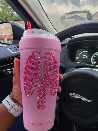 Customer's pink To-Go Buddy cup with a rhinestone skeleton ribcage design, held inside a car.