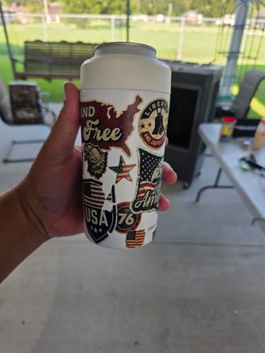 Customer's hand holding a Universal Buddy can cooler with patriotic themed stickers.