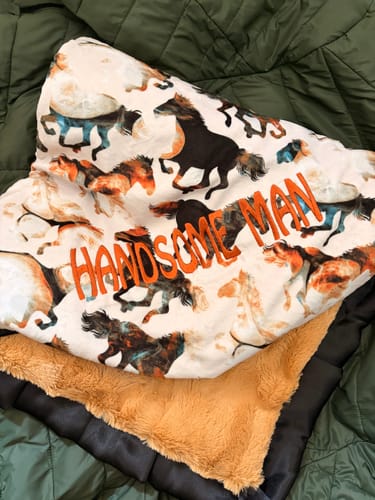 Customer's Personalized Custom Minky blanket with a horse pattern and the embroidered text Handsome Man.