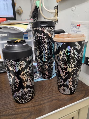 Customer's three Metallic Venom Thicc Buddy mugs with holographic snake pattern, displayed together on a desk.