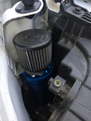 Customer's blue remote catch can installed behind the driver's side headlight.