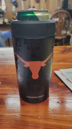 Customer's Texas Longhorns Universal Buddy can cooler sitting on a wood table with a drink inside.