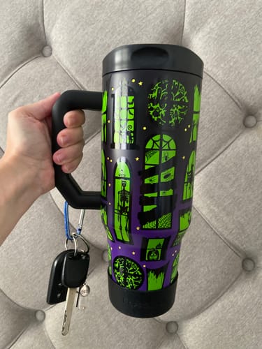 Customer's Thicc Buddy 40oz Midnight Manor mug held by a hand, showing the patterned lid and keys attached to the handle.