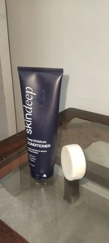 Customer's Hair Revival Set featuring a dark blue tube of deep conditioner next to a small white shampoo bar.