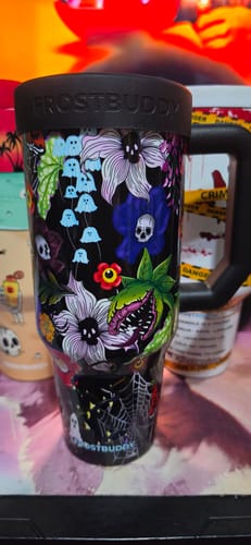 Customer's Thicc Buddy cup in Toxic Bloom design featuring ghosts, skulls, and flowers on a black background