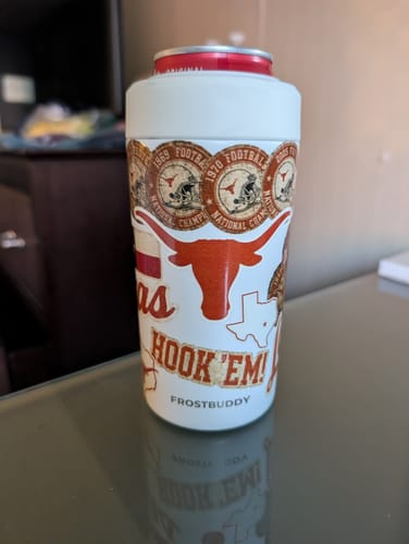 Customer's white Universal Buddy can cooler featuring Texas Longhorns stickers, sitting on a table.