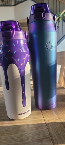 Customer's two colorful Frost Buddy water bottles standing on a wooden surface.