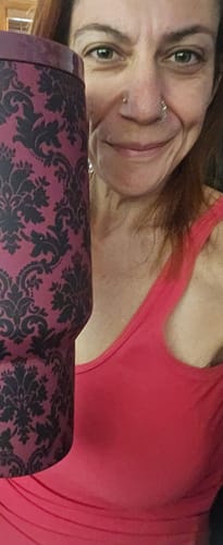 Reviewer holding the 50oz Thicc Buddy mug with a purple damask pattern.