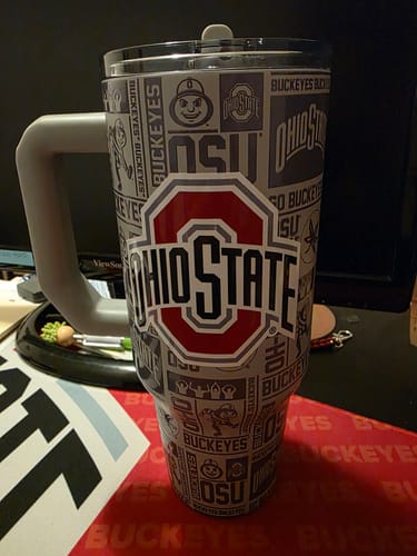 Customer's Thicc Buddy 40oz Ohio State mug with a bold logo and patterned exterior, sitting on a desk.