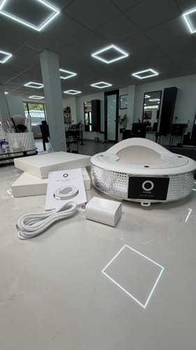 Customer's white ONAIL Tornado Dust Collector with power cable and manual on a table.