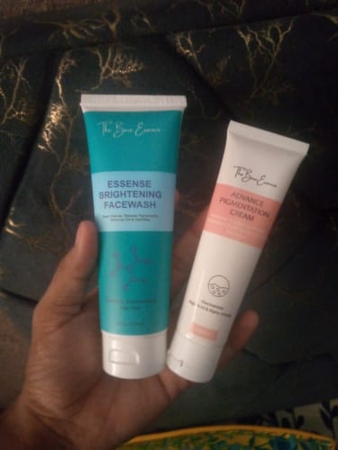 Customer's hand holding the Eco Pigmentation Bundle, featuring the teal-labeled facewash and white-labeled cream tubes.
