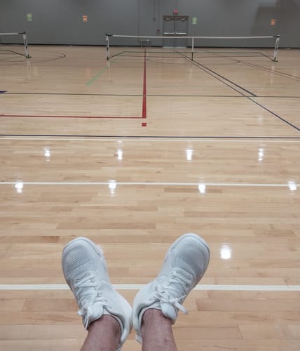 Customer's white Cuurt Muuv wide toe box court shoes worn on an indoor sports court.