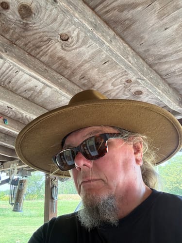 Reviewer's wide brim felt hat, close-up side profile view.