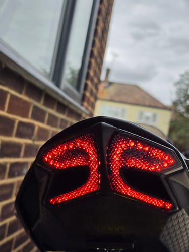 Customer's motorcycle featuring the installed bright red LED tail light assembly after Bracket Fitment Service.