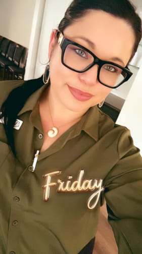 Reviewer wearing a gold Hailey Bubble Initial Necklace, looking at the camera.