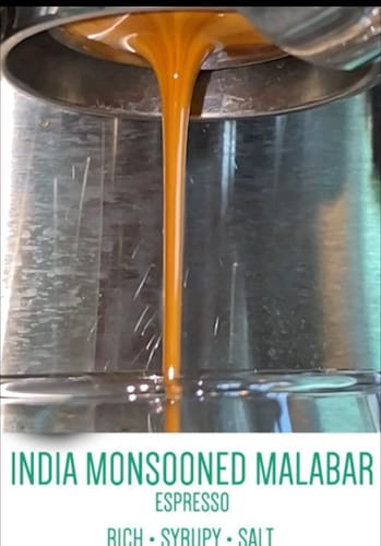 Customer's India Monsooned Malabar espresso pouring into a glass, showing thick, creamy foam.